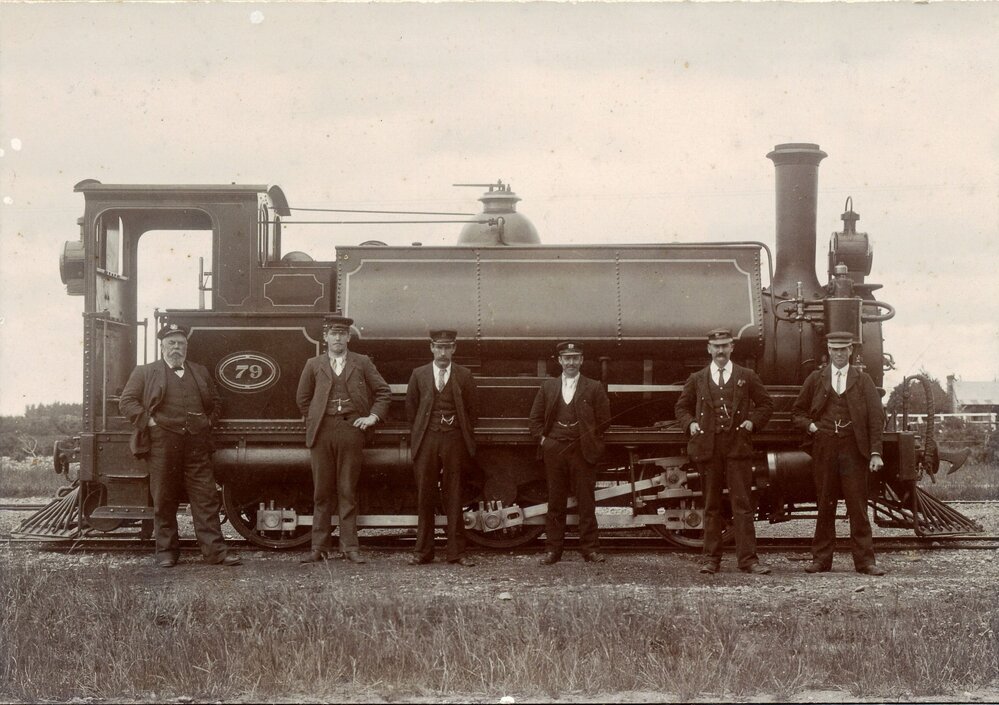 An &lsquo;F&rsquo; class railway locomotive no.79 probably &lsquo;The Punt&rsquo; at Bennetts with New Zealand Railway staff including the engine driver George Stirling. Date 1906/7