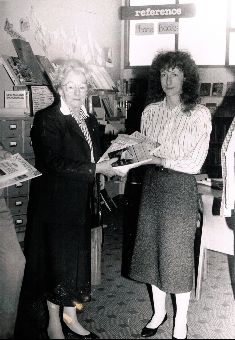 Dorothy Harris presenting the Waimakariri District Librarian, Michelle Manning, with new books, 25 May 1990