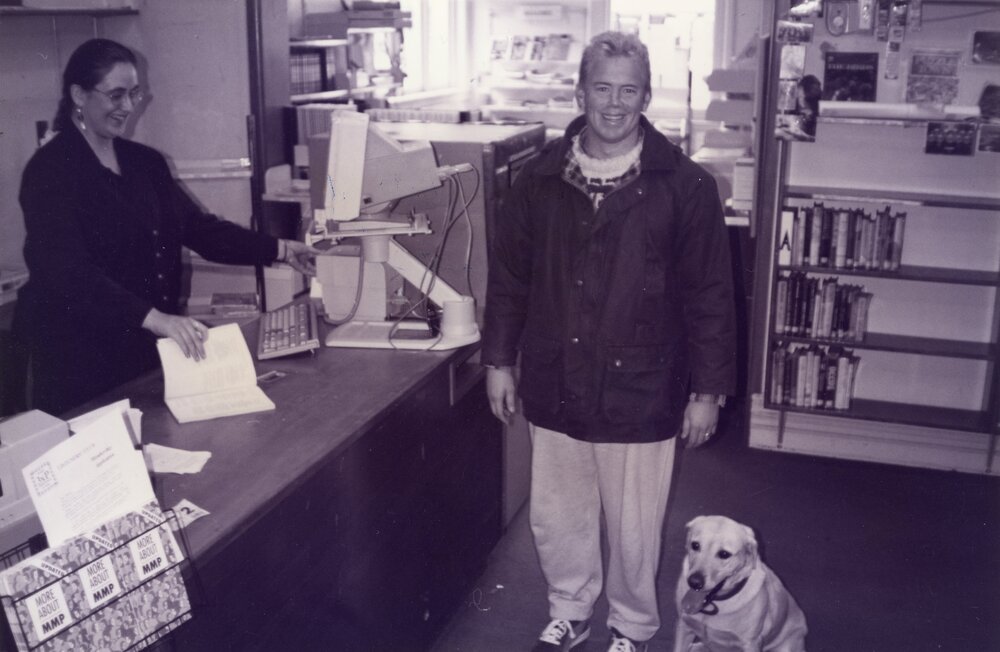 Librarian Debbie Lambert issuing the last book in the old Rangiora Public Library on Percival Street, c. May 1996