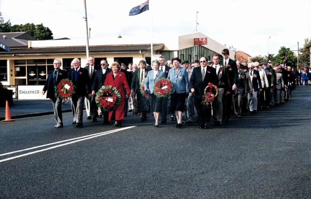 Wreath bearers lead Anzac Day Parade along Victoria Street