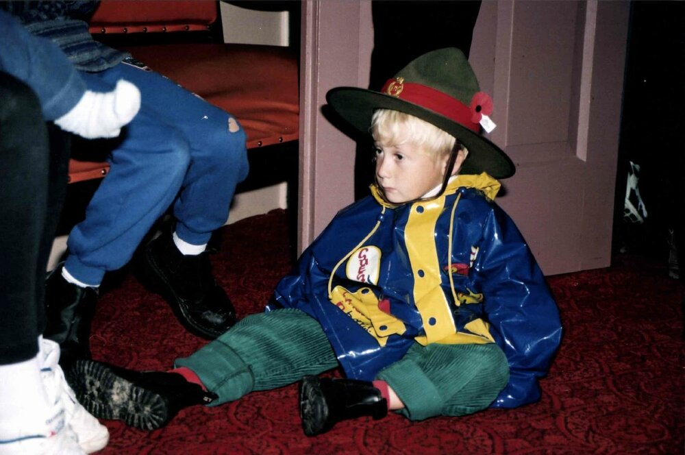 Young lad waits patiently during Anzac Day service in the Rangiora Town Hall April 2000