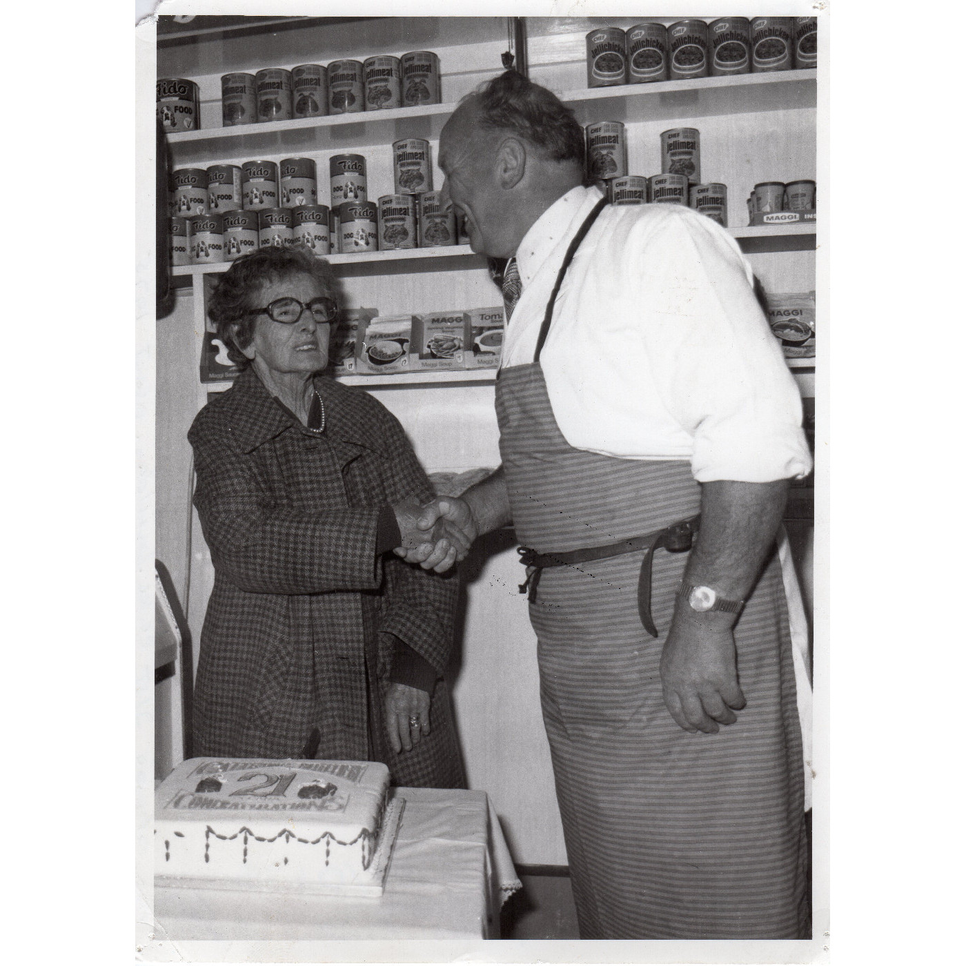A. Cattermole Butcher and Mrs Britsow with the business's 21st celebration cake, Kaiapoi