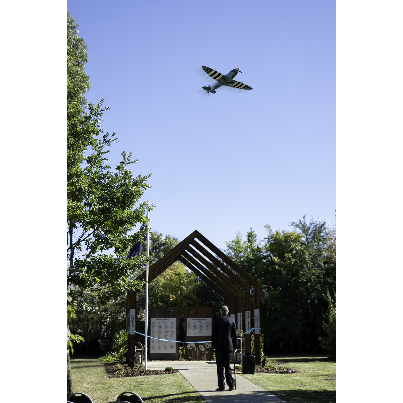 A replica Spitfire flies over the unveiling of the Loburn War Memorial, 2025