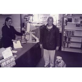 Librarian Debbie Lambert issuing the last book in the old Rangiora Public Library on Percival Street, c. May 1996