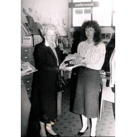 Dorothy Harris presenting the Waimakariri District Librarian, Michelle Manning, with new books, 25 May 1990