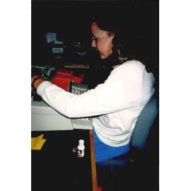 Librarian Nicki Chaston at work in the old Rangiora Public Library, c. November 1990