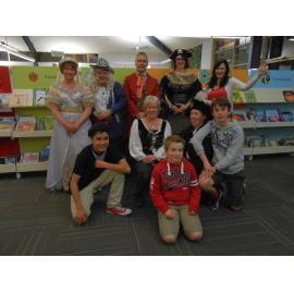 Waimakariri Libraries staff with children, dressed up for KidsFest Quiz Night at the Trevor Inch Memorial Library, c. 2015