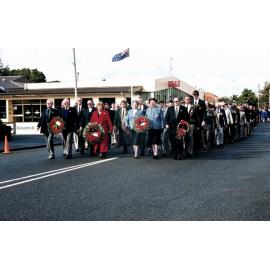 Wreath bearers lead Anzac Day Parade along Victoria Street